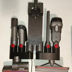 Wall mount attachment holder docking a Dyson V8 vacuum with four tool slots