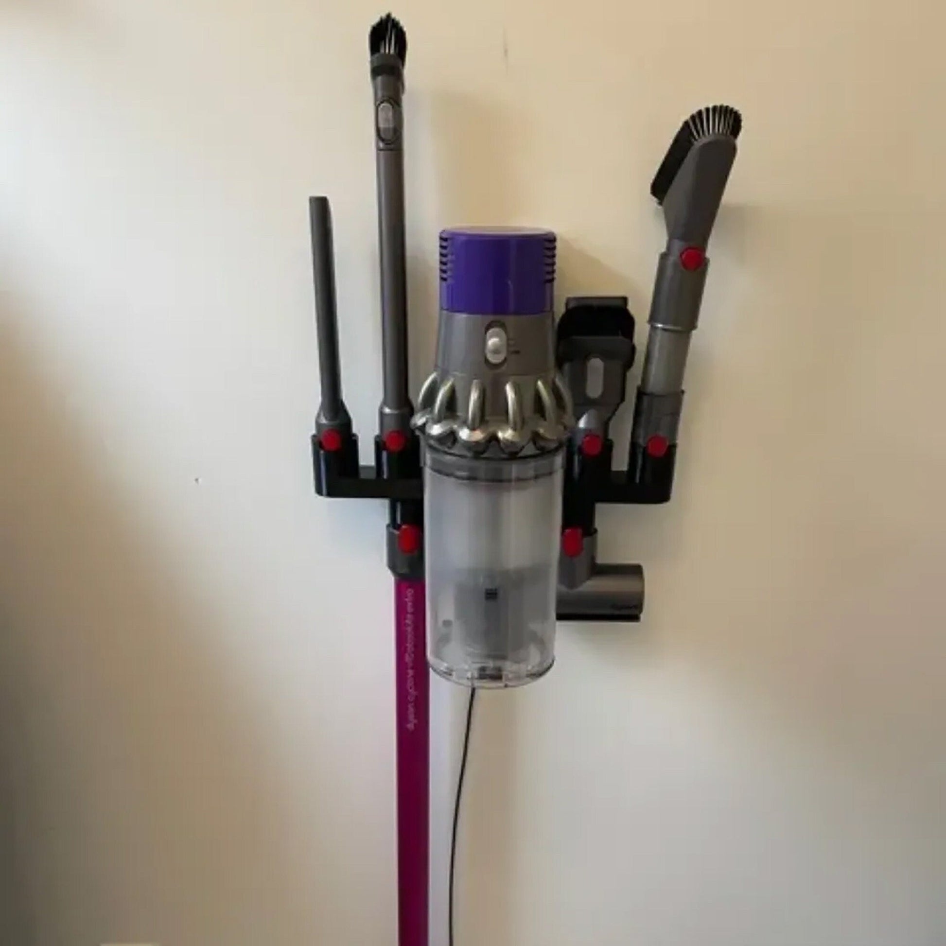 a close up of a vacuum and a wall mounted device