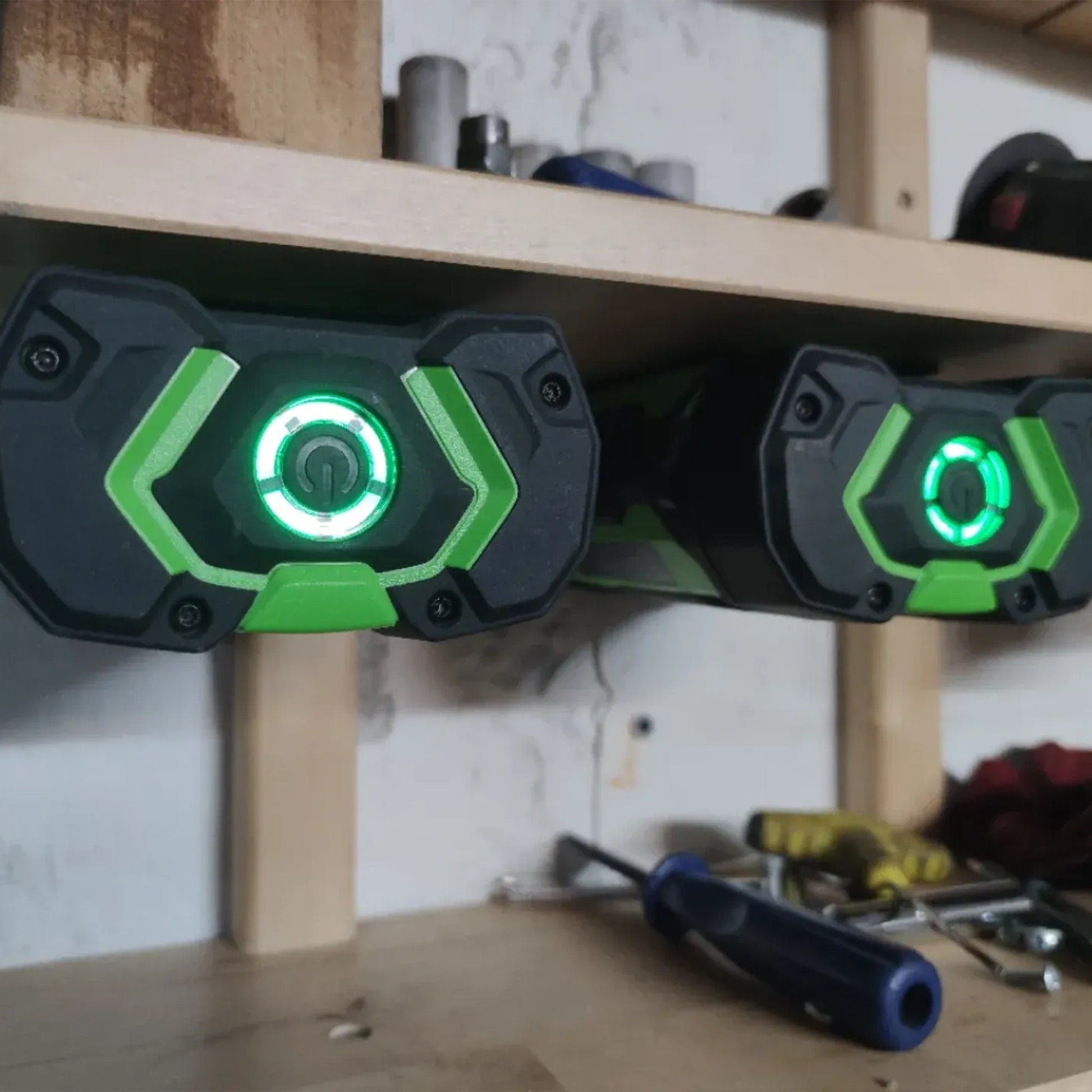 a couple of green lights sitting on top of a wooden shelf