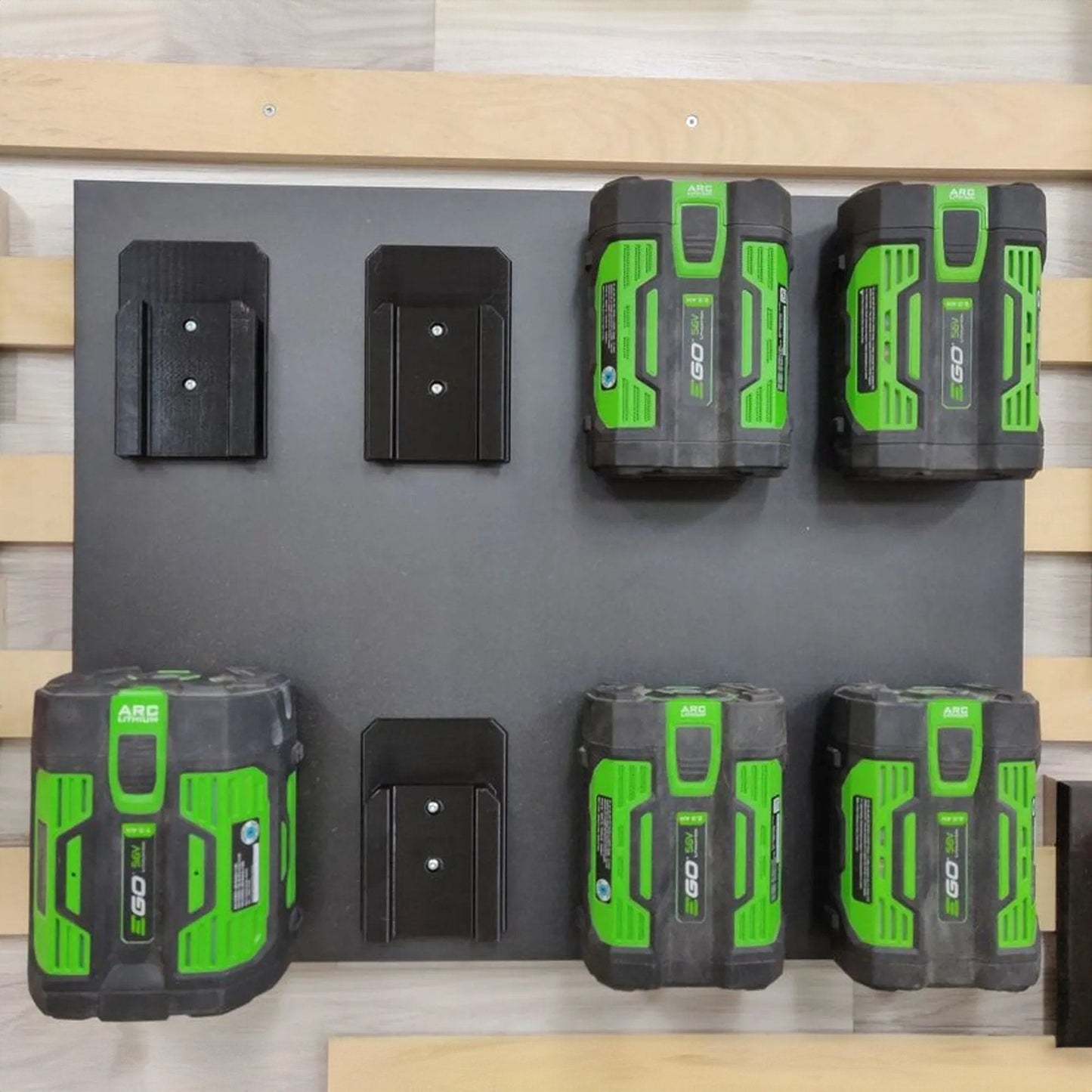 a group of green and black batteries on a wall