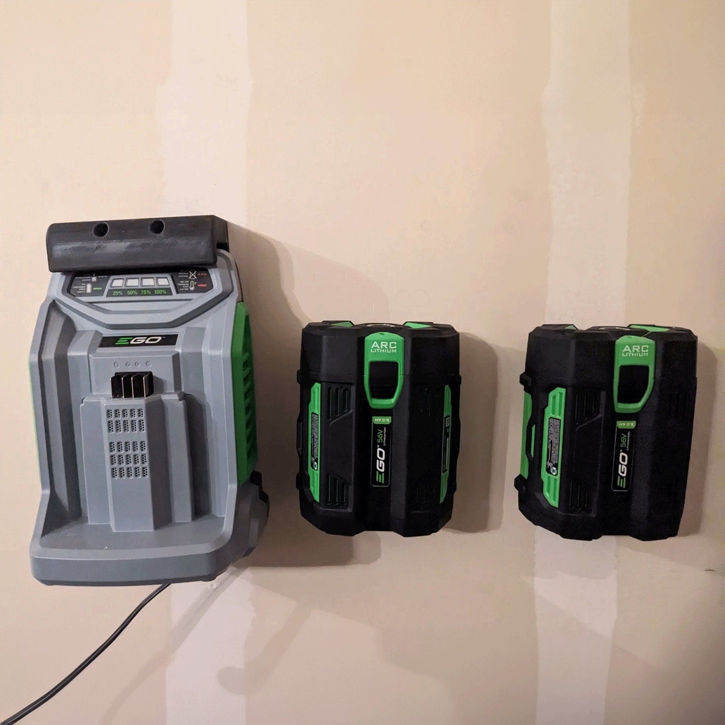 three green and black batteries attached to a wall