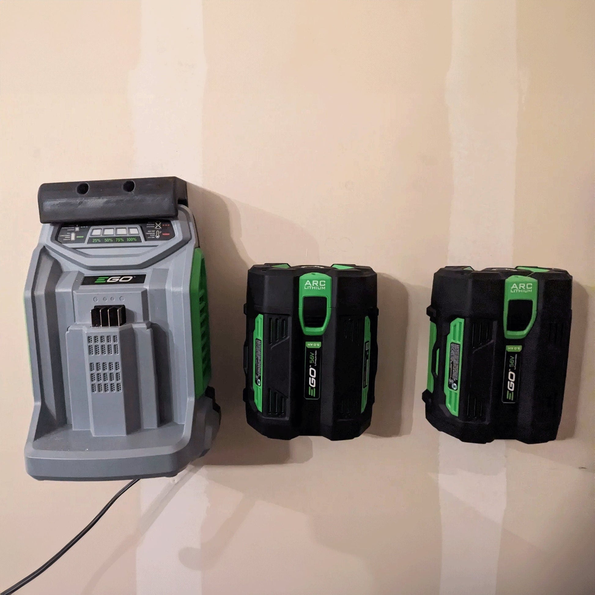 three green and black batteries attached to a wall