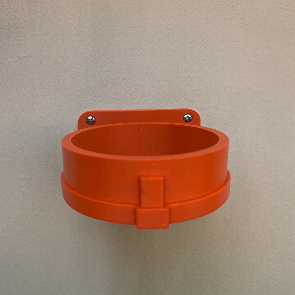 Wall mount holder cradling an EGO Power Plus leaf blower turbo nozzle