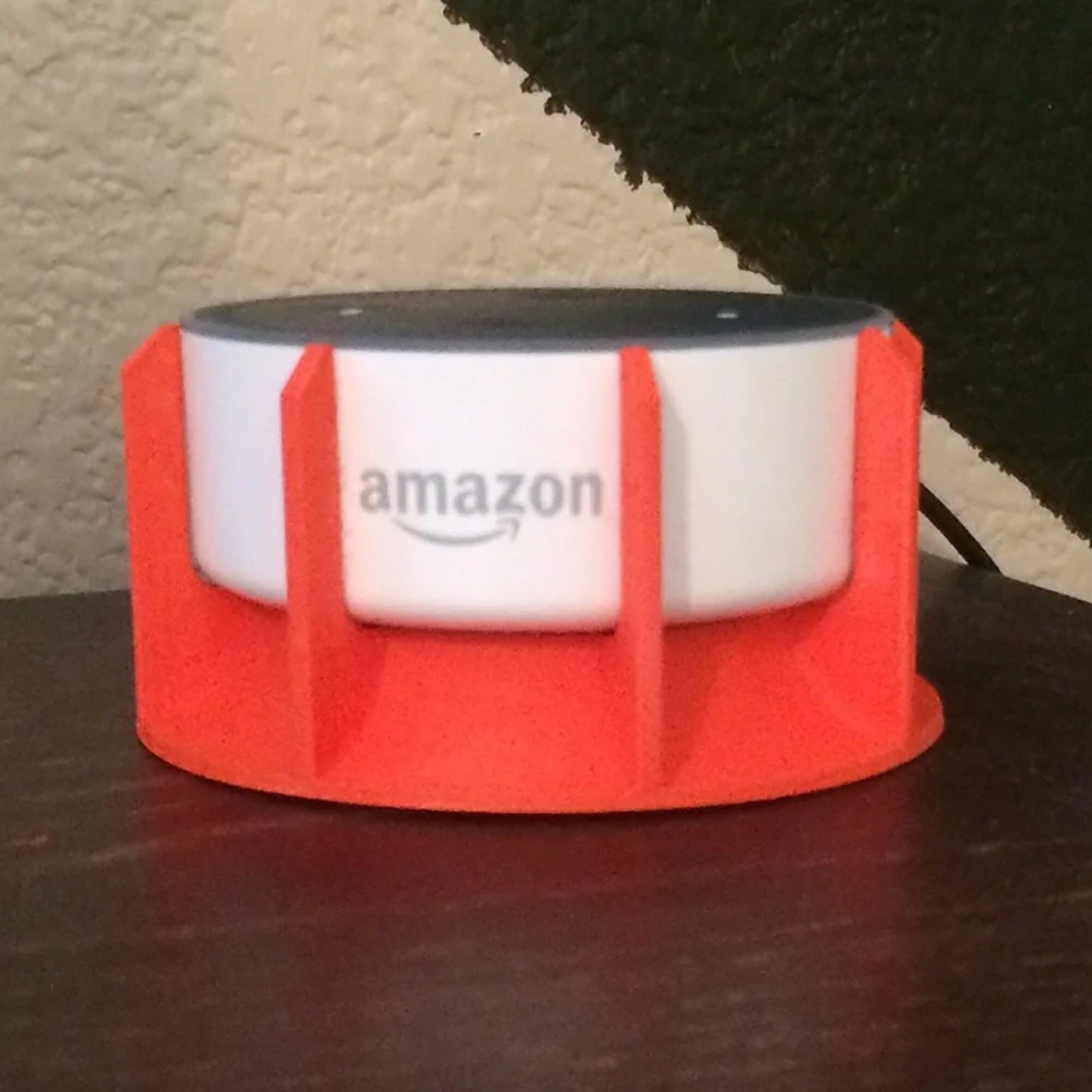 a red and white speaker sitting on top of a wooden table