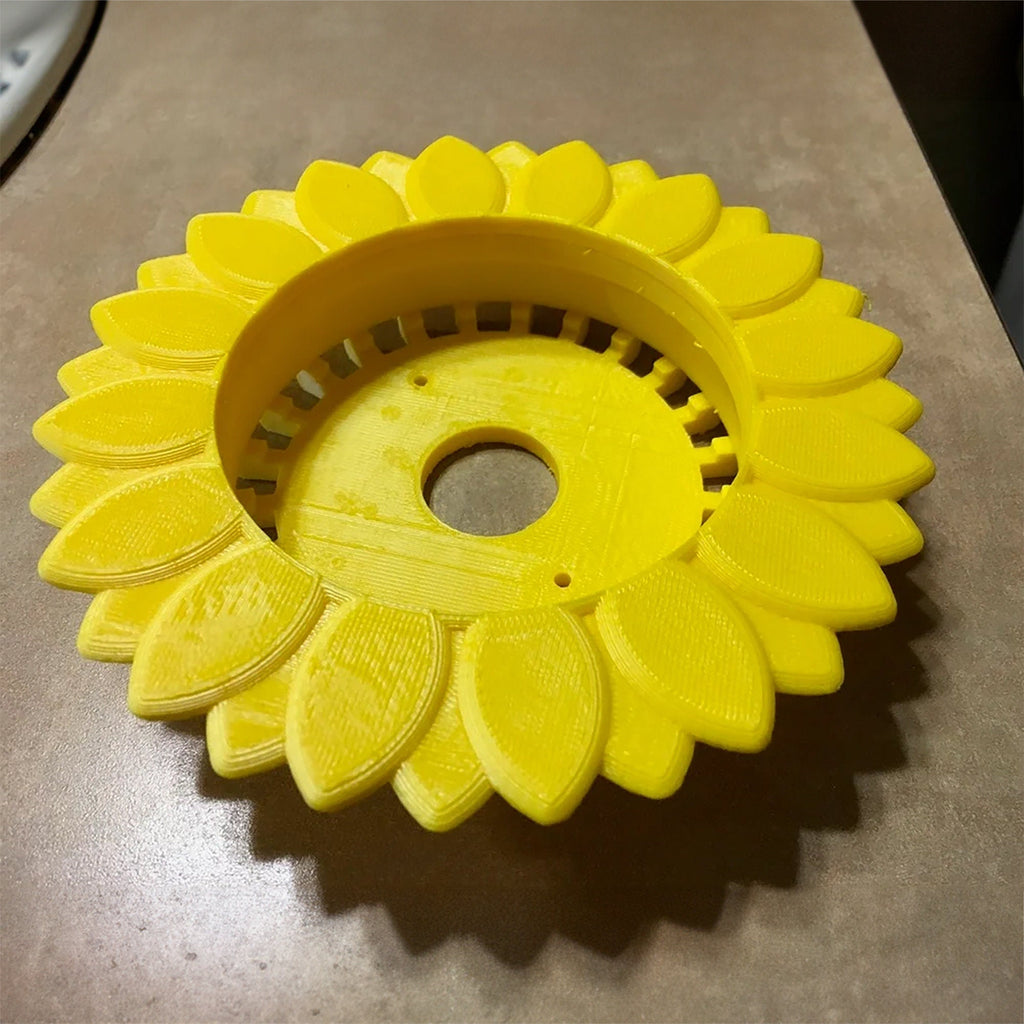 Sunflower stand with layered petals framing a puck-style Echo Dot speaker, view 5