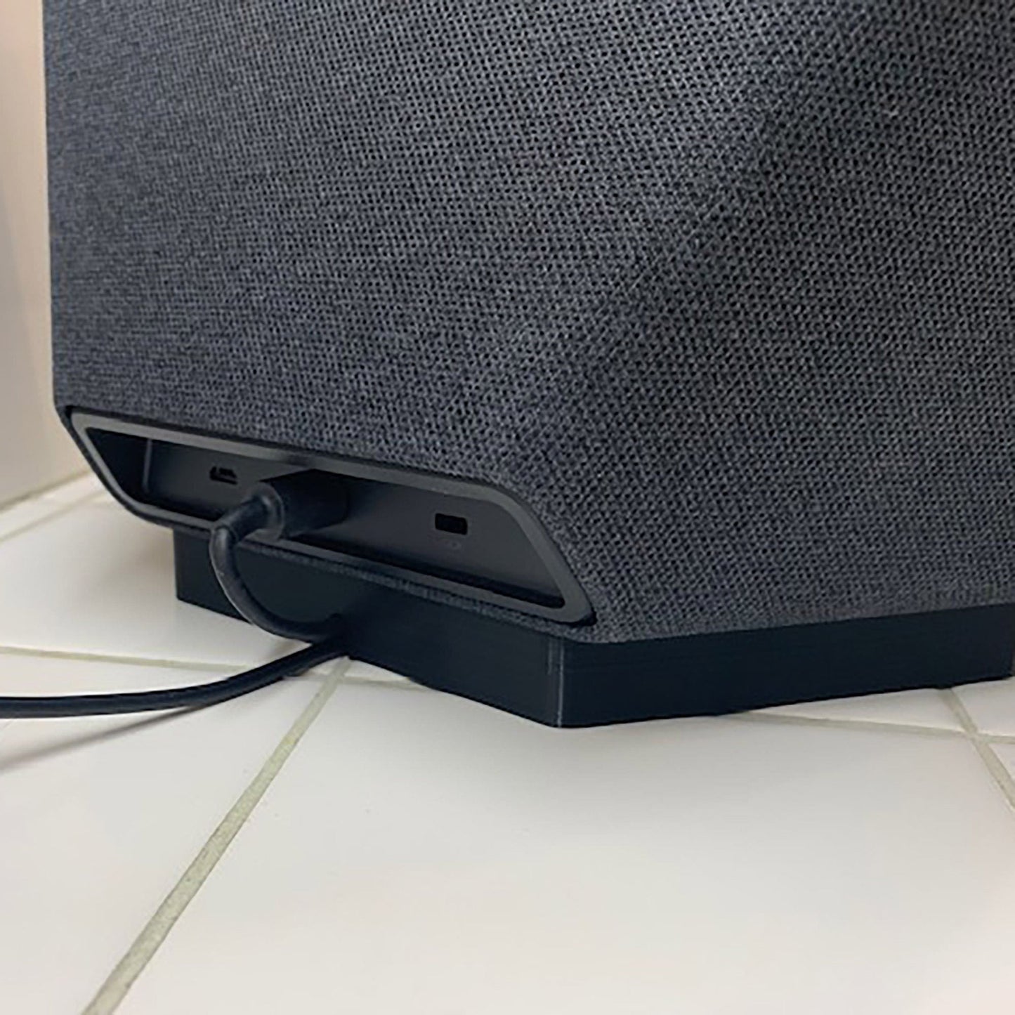 a close up of a speaker on a tiled floor