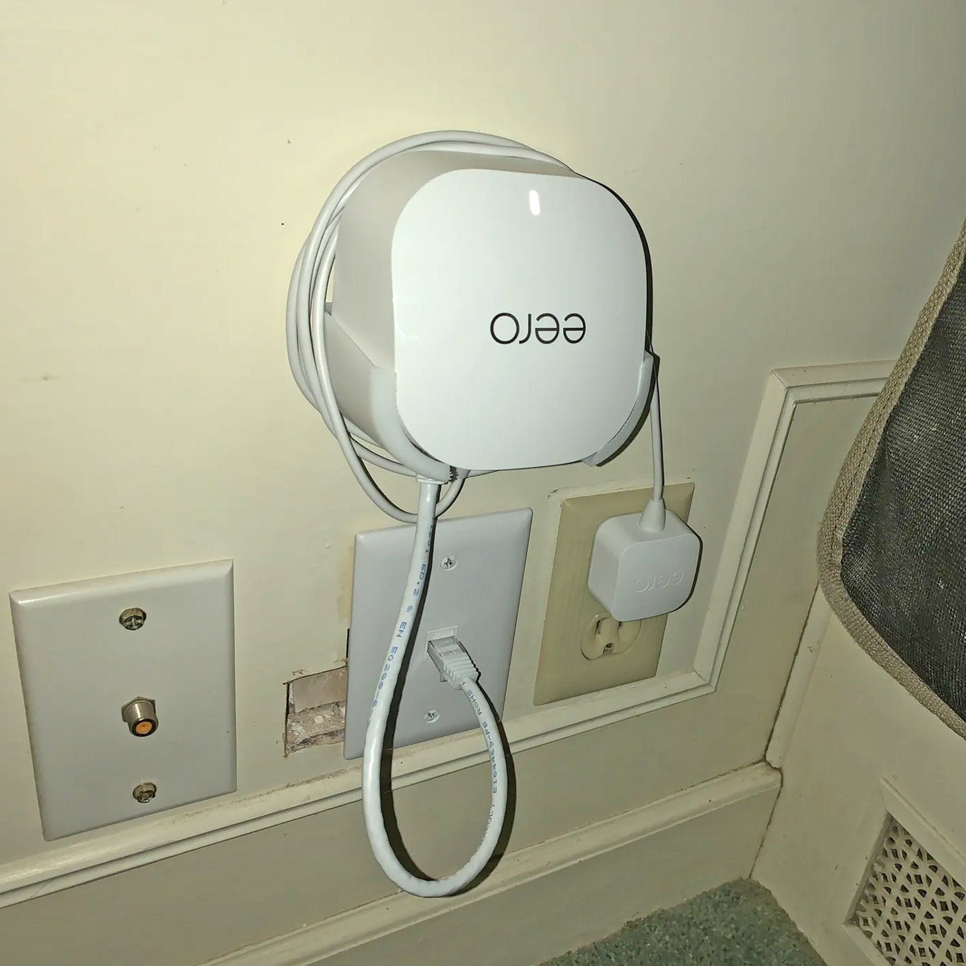 a wall mounted device with a cord attached to it