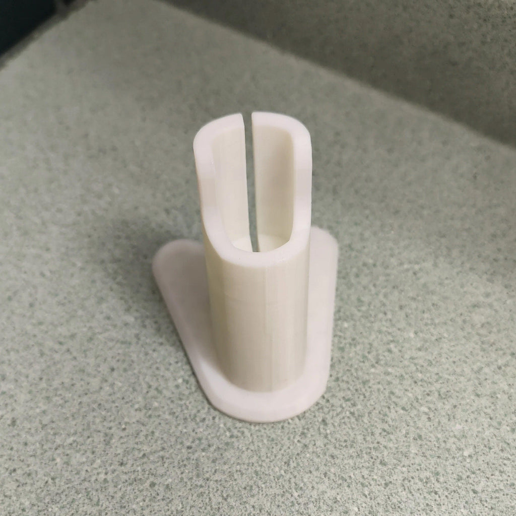 Charging stand holding a Philips OneBlade QP2520 razor upright, view 3