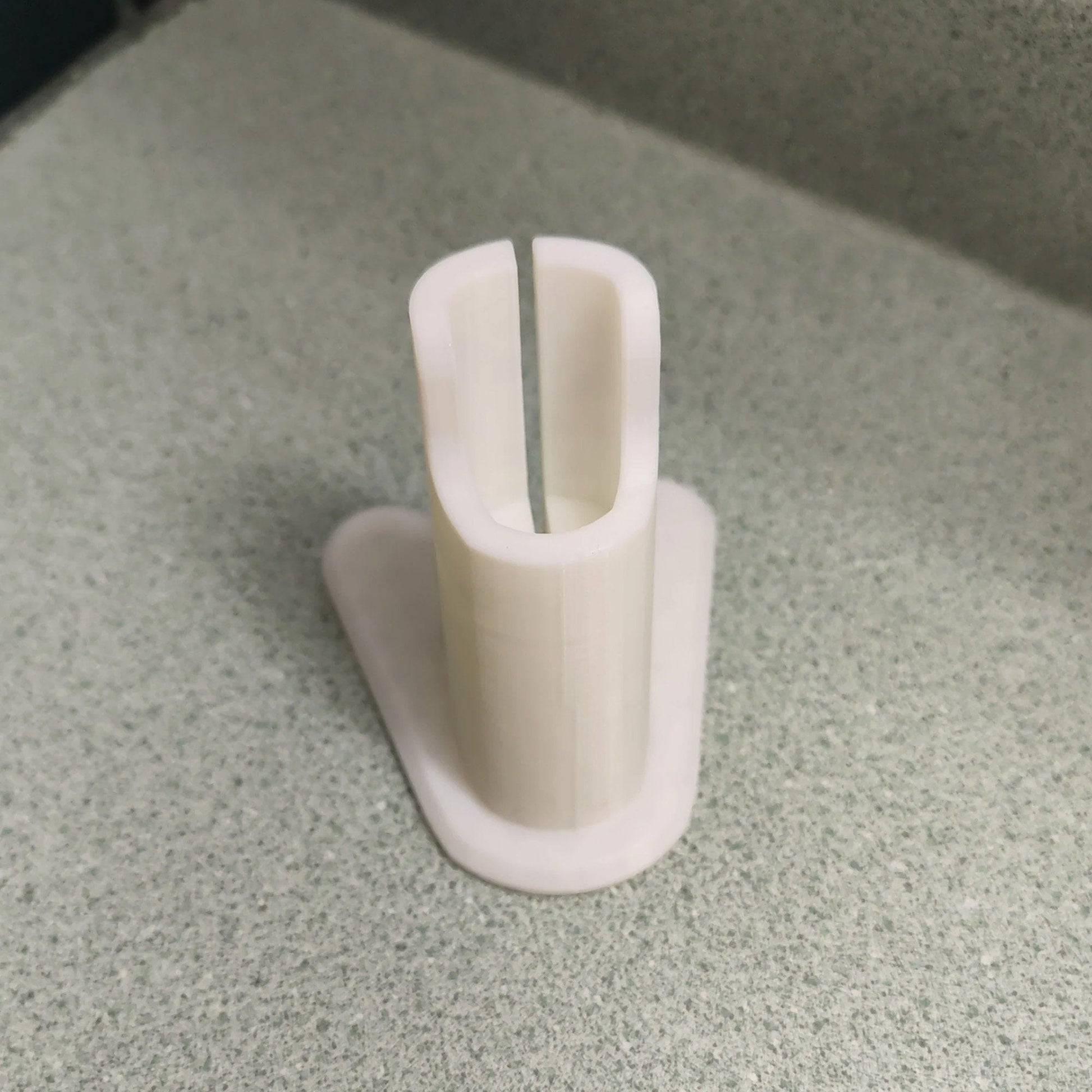 a close up of a toothbrush holder on a counter