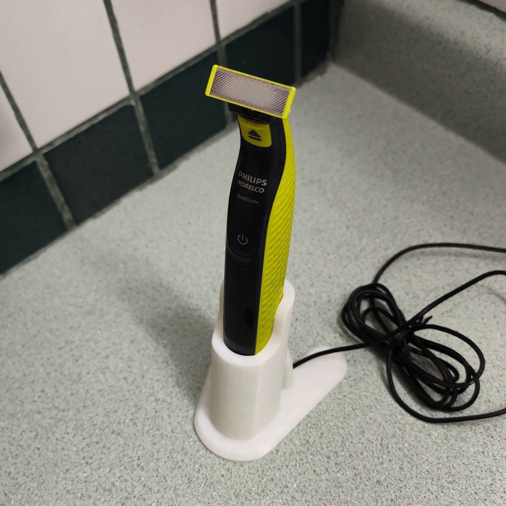 Charging stand holding a Philips OneBlade QP2520 razor upright