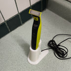 Charging stand holding a Philips OneBlade QP2520 razor upright