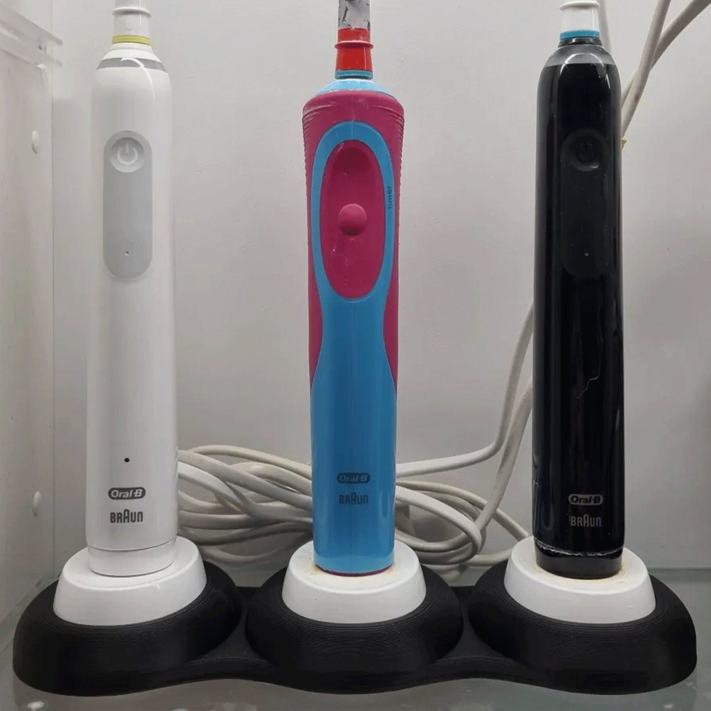 a couple of electric toothbrushes sitting next to each other