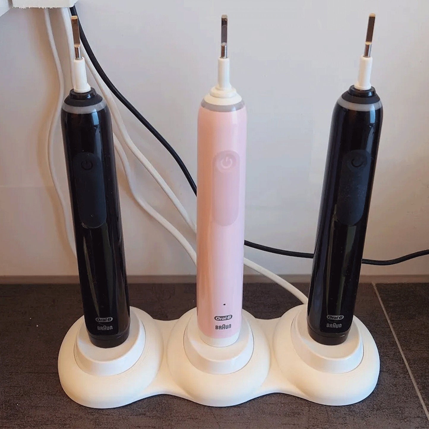 a couple of electric toothbrushes sitting on top of a table