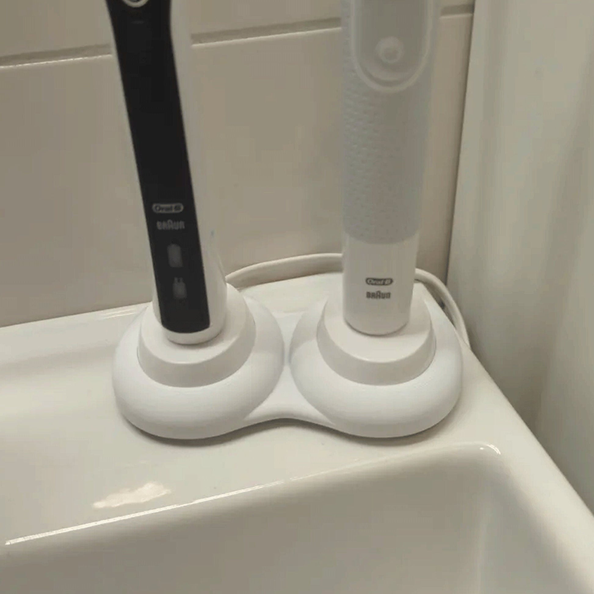 a toothbrush and toothpaste dispenser in a bathroom