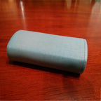 Tall travel cap covering an Oral-B brush head on its stand, view 2