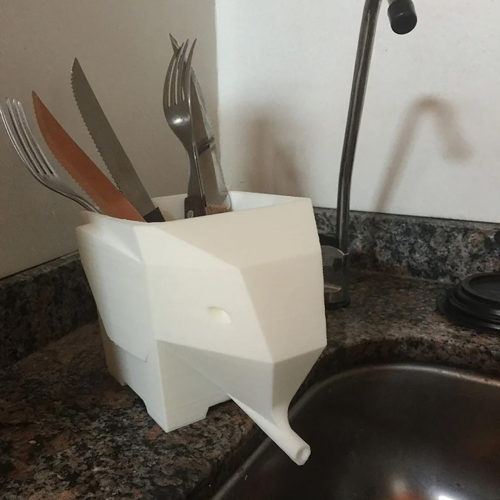 Geometric elephant utensil holder draining cutlery into the sink, view 2