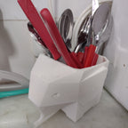 Geometric elephant utensil holder draining cutlery into the sink