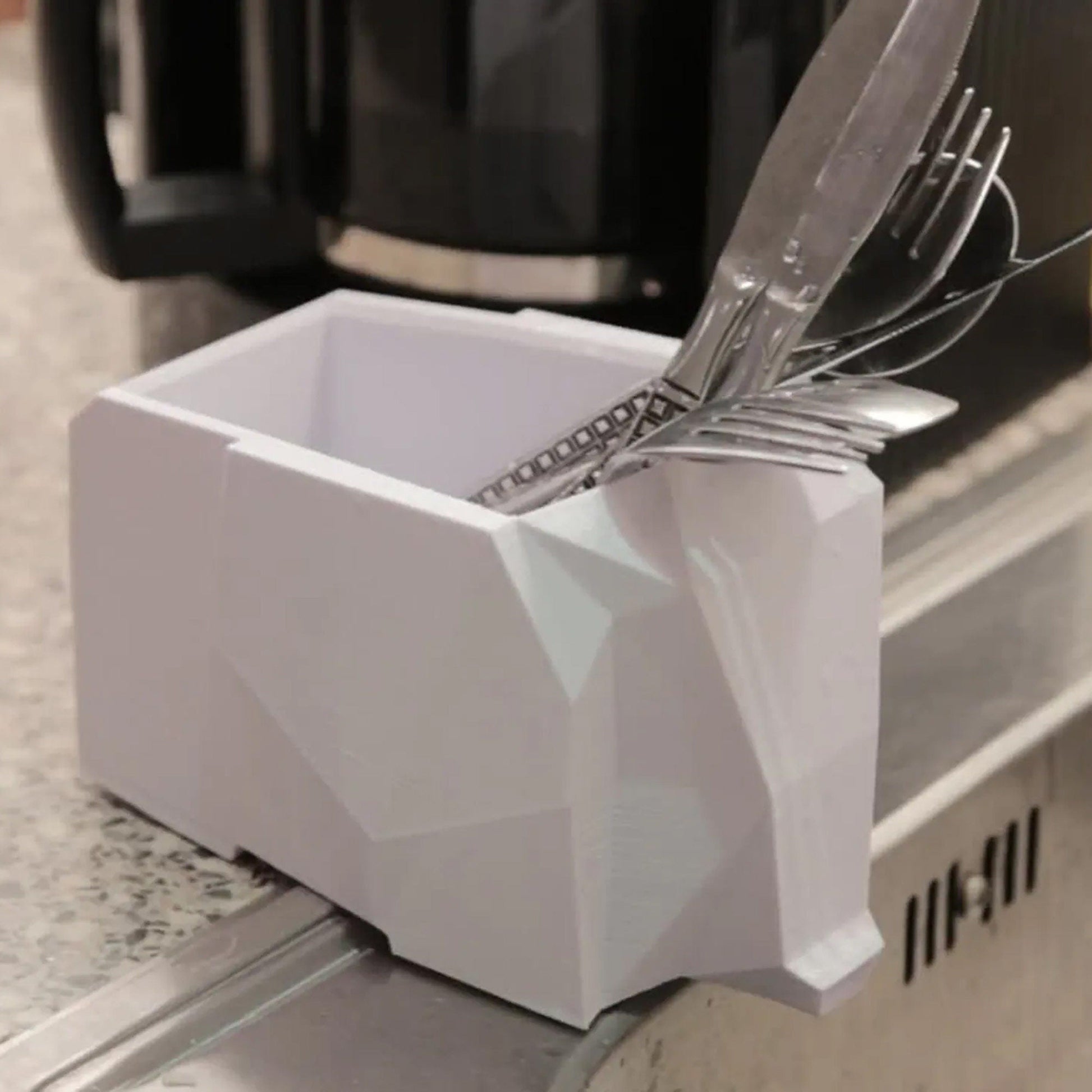 a knife and fork holder on a stove