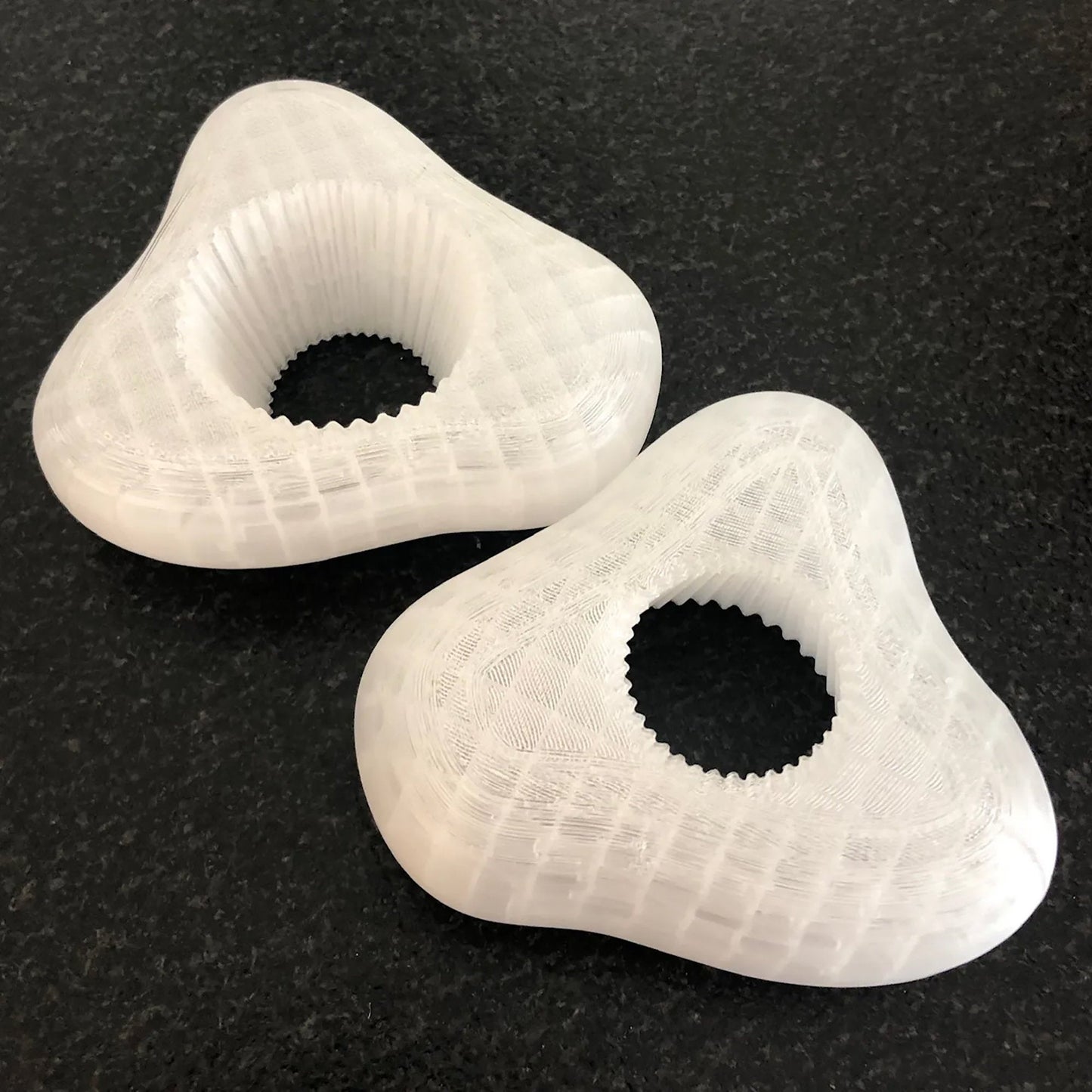 a pair of white shoes sitting on top of a black counter