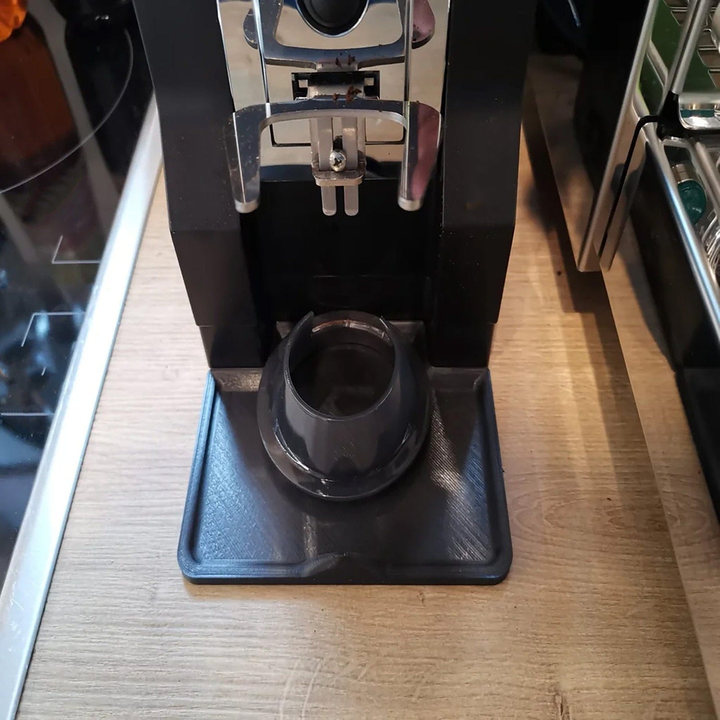 a coffee maker sitting on top of a wooden counter