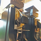 Spout funnel clipped onto a Eureka Mignon grinder chute above a portafilter, view 4