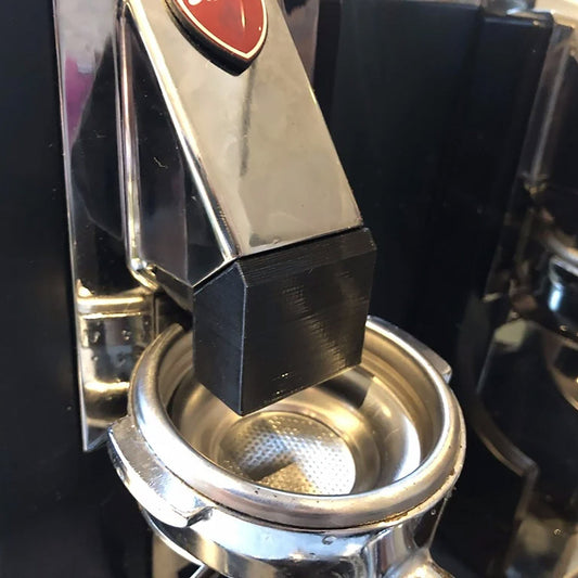 a close up of a coffee maker with a red heart on it