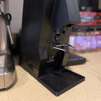 Tilting single dosing base with catch tray holding a Eureka Mignon Specialita at 15 degrees, view 2