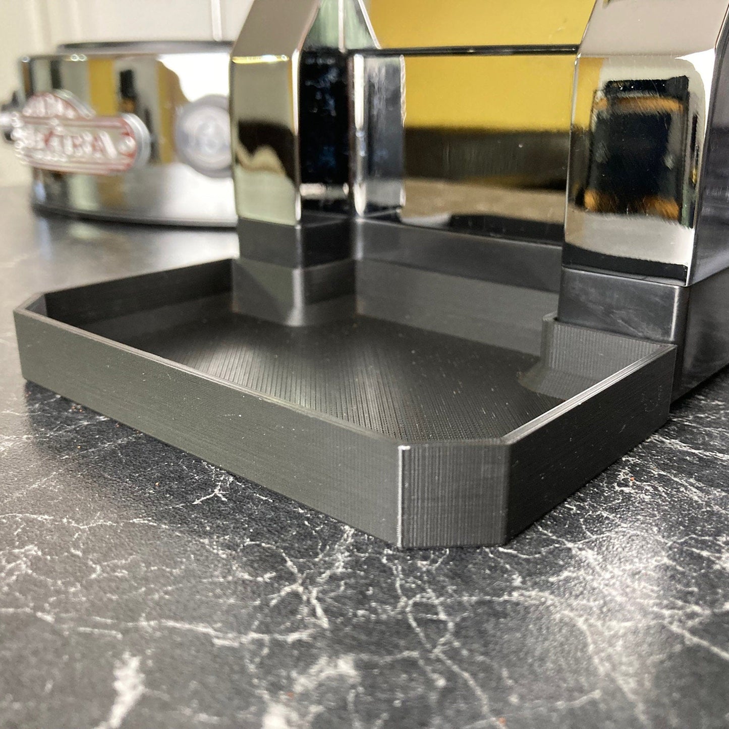 a black marble counter top with a mirror on top of it