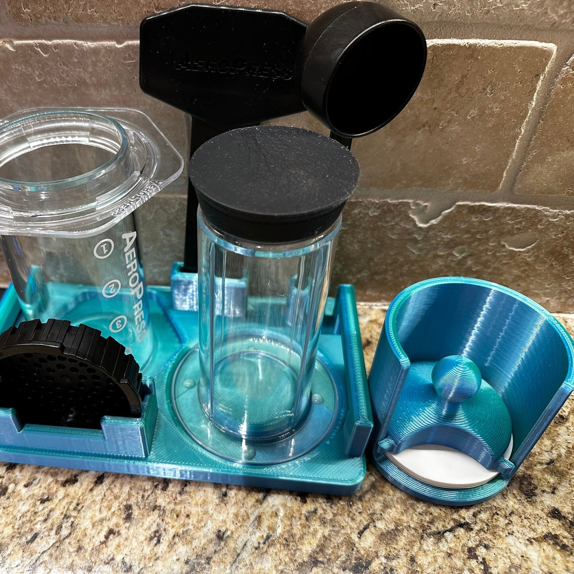 a blender sitting on top of a counter next to a cup