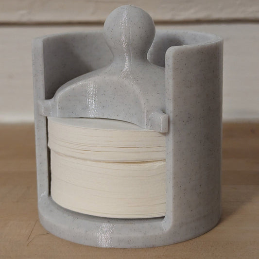 a ceramic sculpture of a person holding a roll of toilet paper
