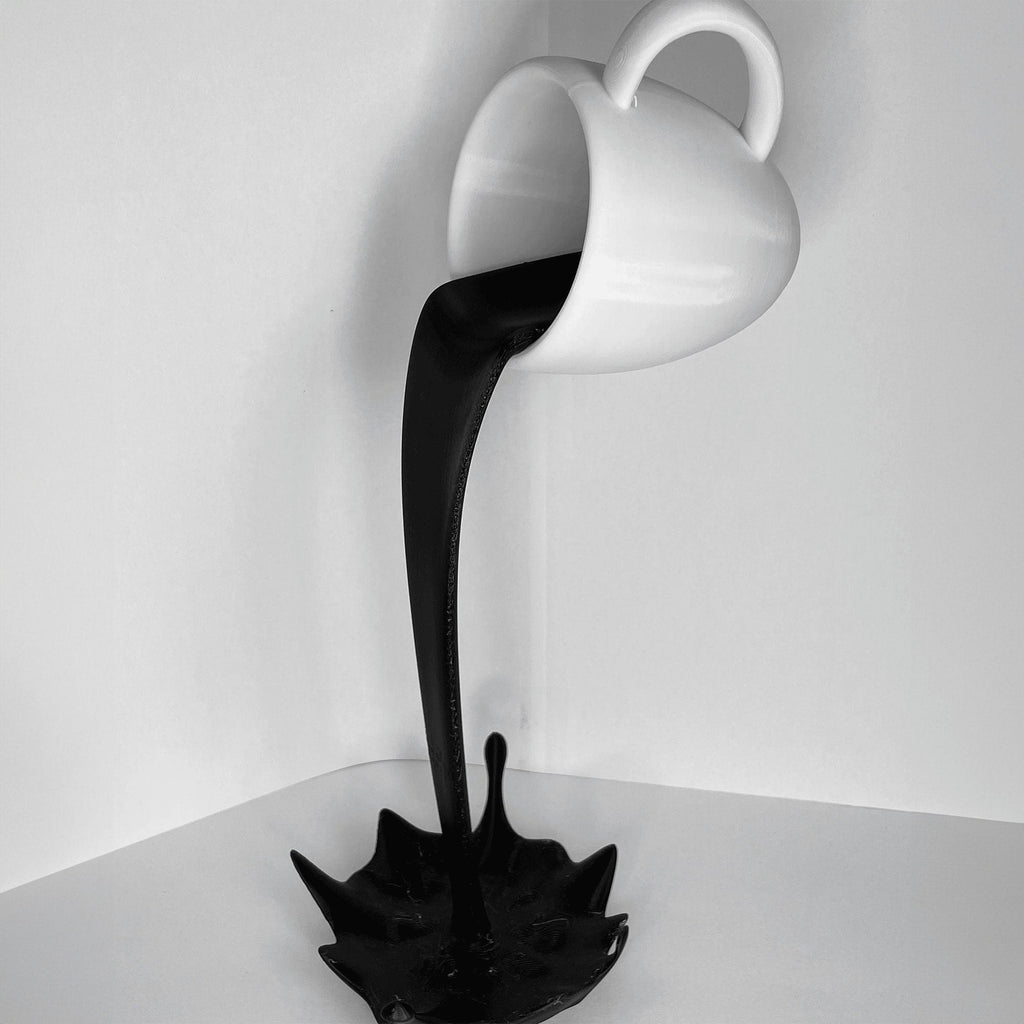 Floating coffee mug sculpture with a coffee stream pouring into a splash puddle, view 3