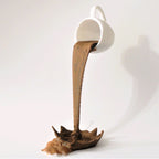 Floating coffee mug sculpture with a coffee stream pouring into a splash puddle, view 4
