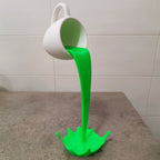 Floating coffee mug sculpture with a coffee stream pouring into a splash puddle, view 5