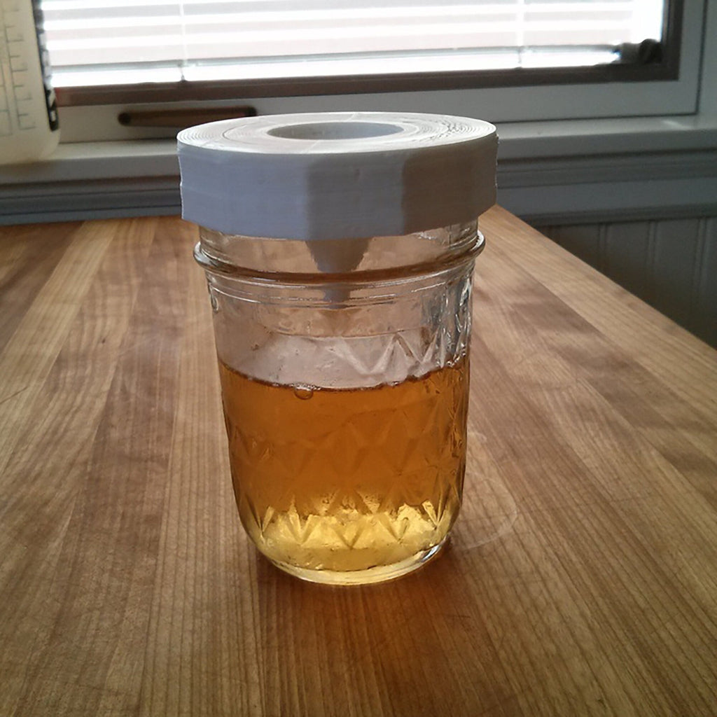 Fruit fly trap lid with inverted cone on a mason jar