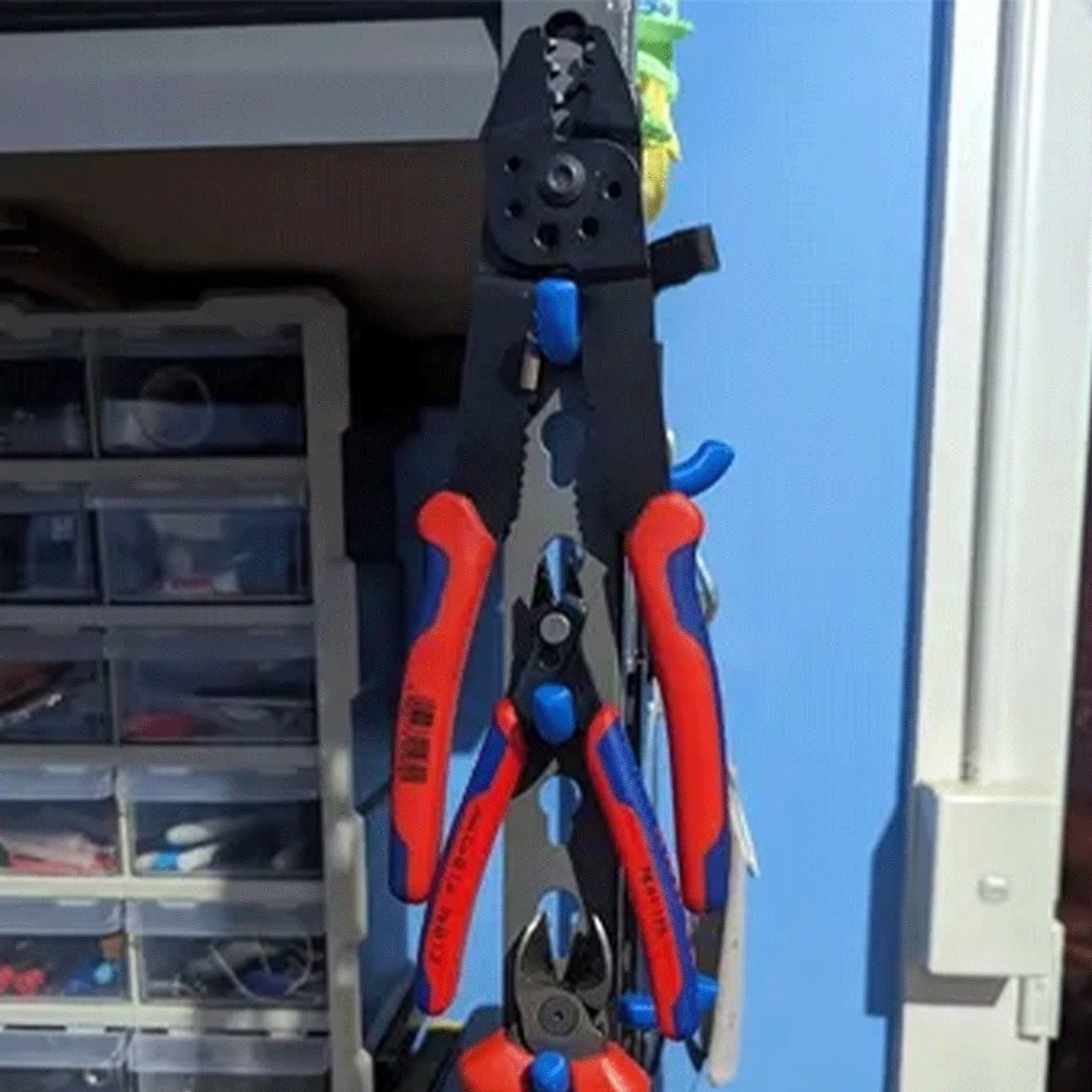 a pair of pliers hanging from a blue door