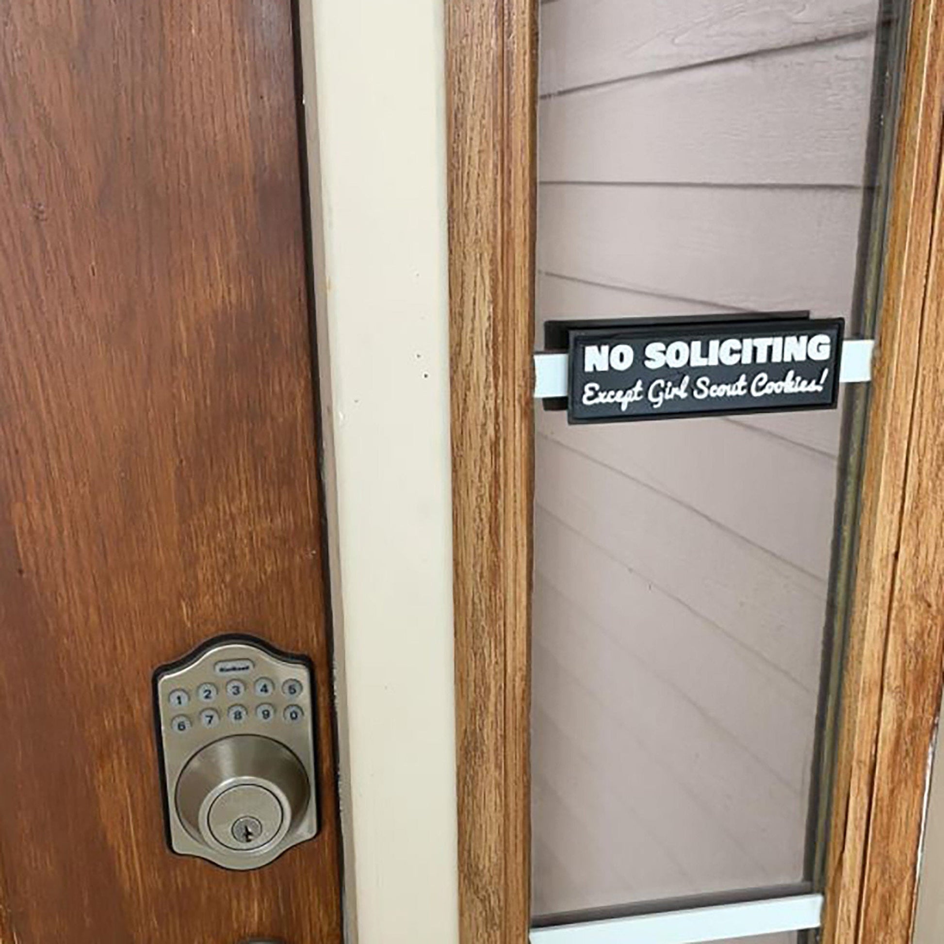 a door handle with a no soliciting sign on it