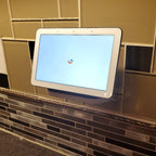 Outlet shelf holding a Google Nest Hub over a wall outlet, view 3