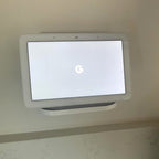 Outlet shelf holding a Google Nest Hub over a wall outlet, view 4