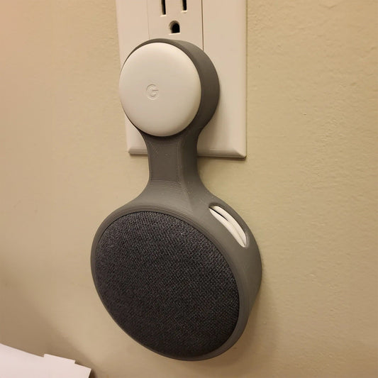 a gray and white speaker mounted to a wall