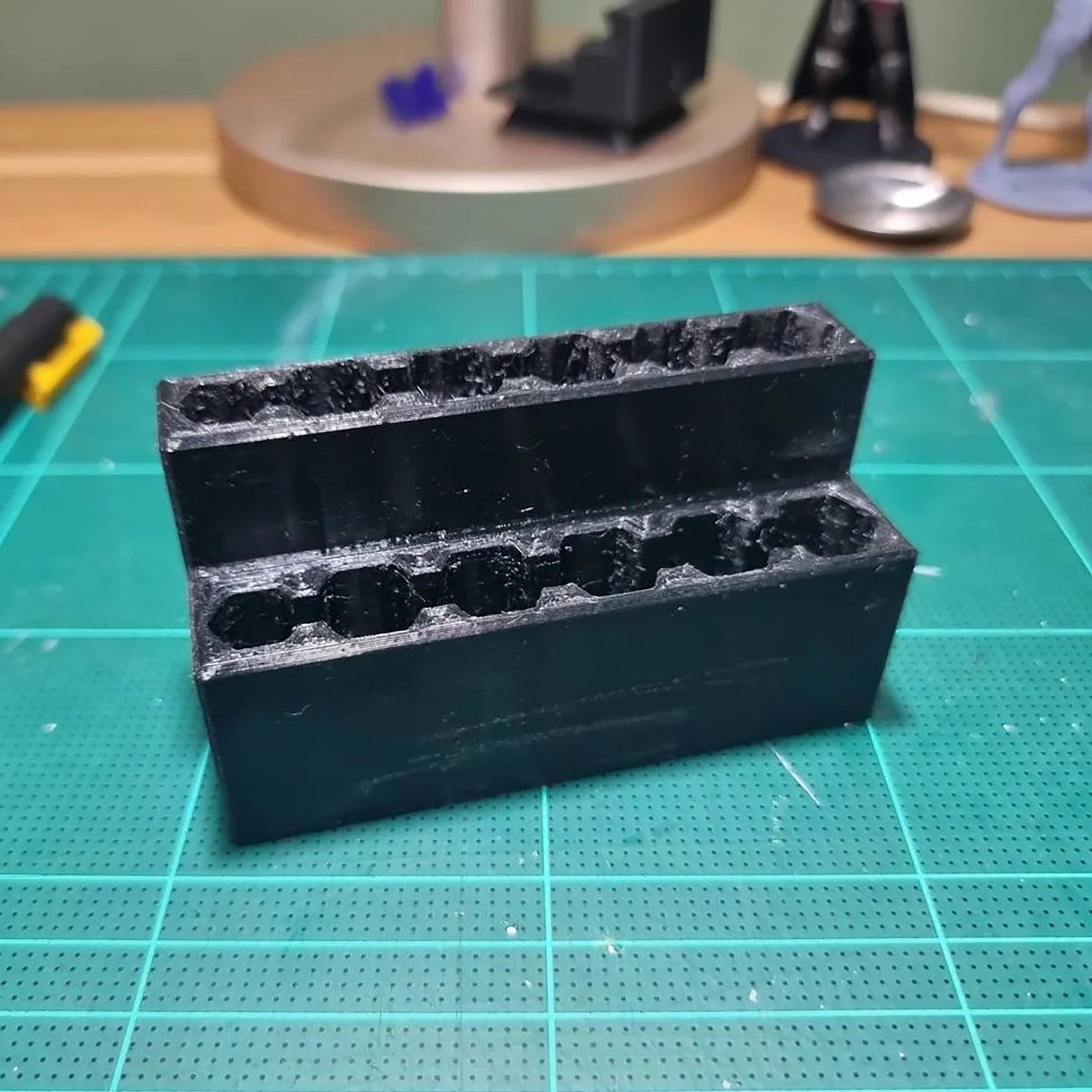 a couple of black plastic containers sitting on top of a table