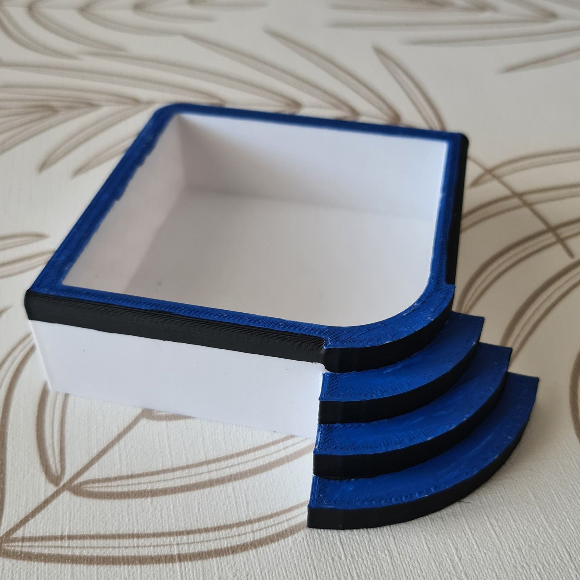 a stack of blue and white boxes sitting on top of a table