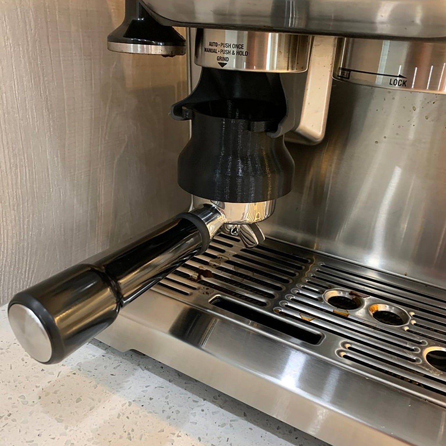 a stainless steel espresso machine sitting on top of a counter