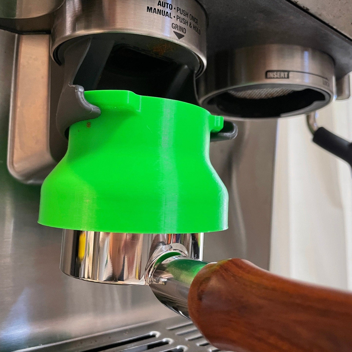 a close up of a machine with a green cup