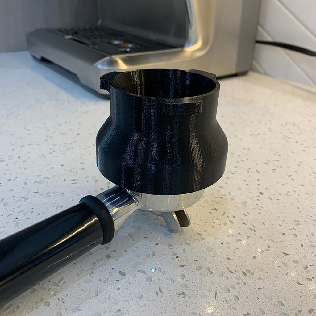Dosing funnel on a 54mm portafilter basket for Breville Barista espresso machines