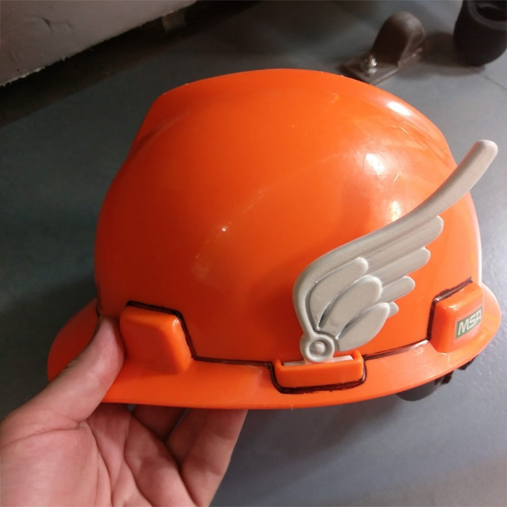 Pair of feathered clip-on wings on the sides of a construction hard hat, view 2