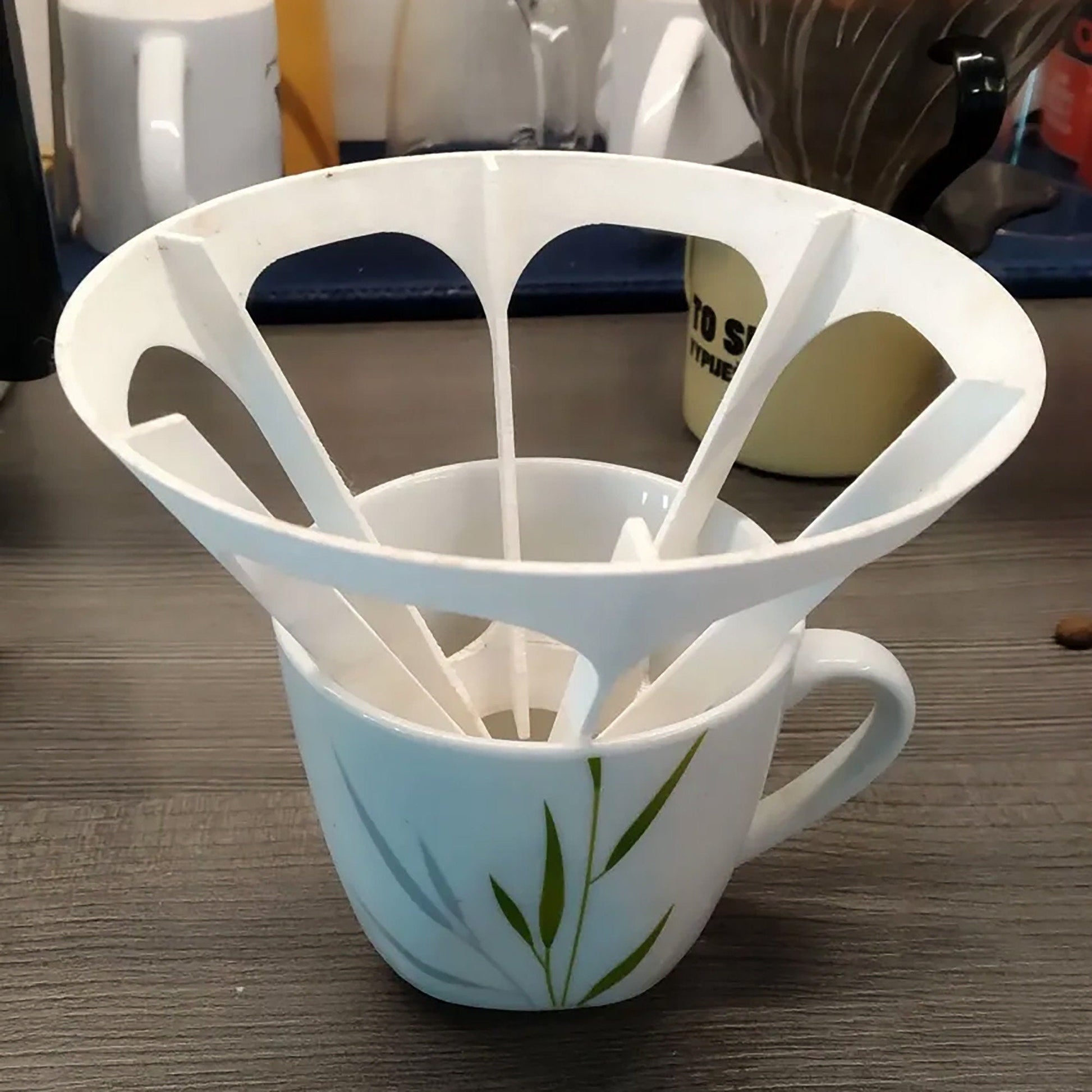 a cup with spoons in it sitting on a table