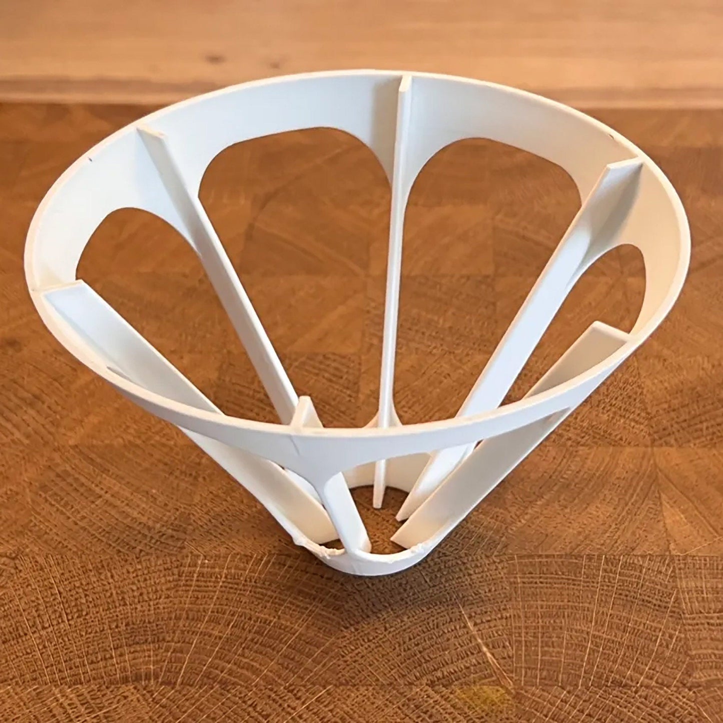 a white bowl sitting on top of a wooden table