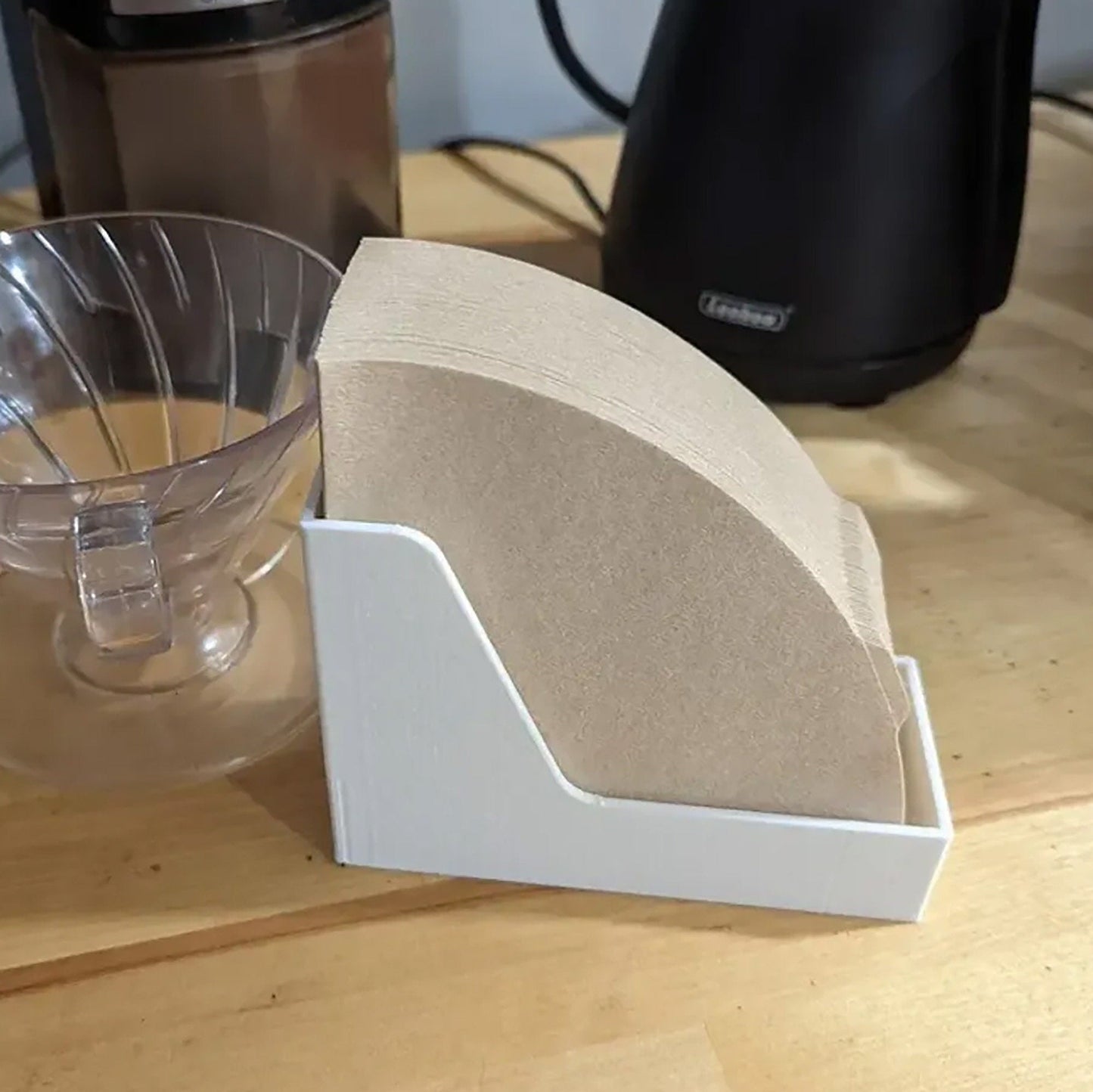 a wooden table with a blender and a cup on it