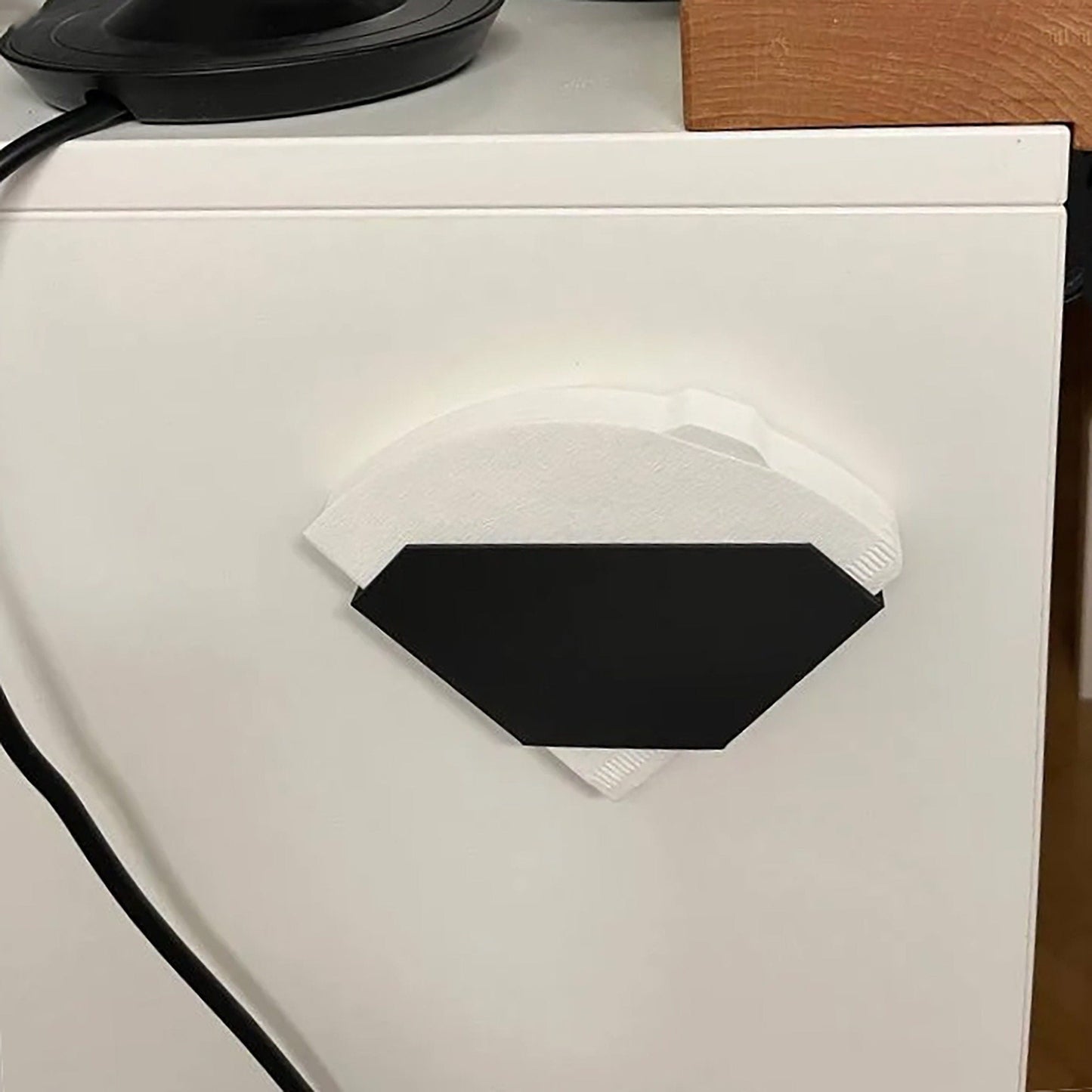 a close up of a white refrigerator with a black handle