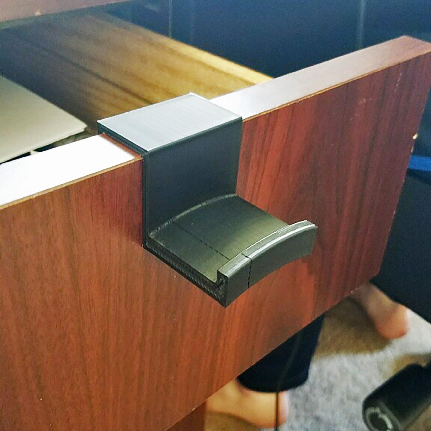 a close up of a wooden desk with a laptop on it